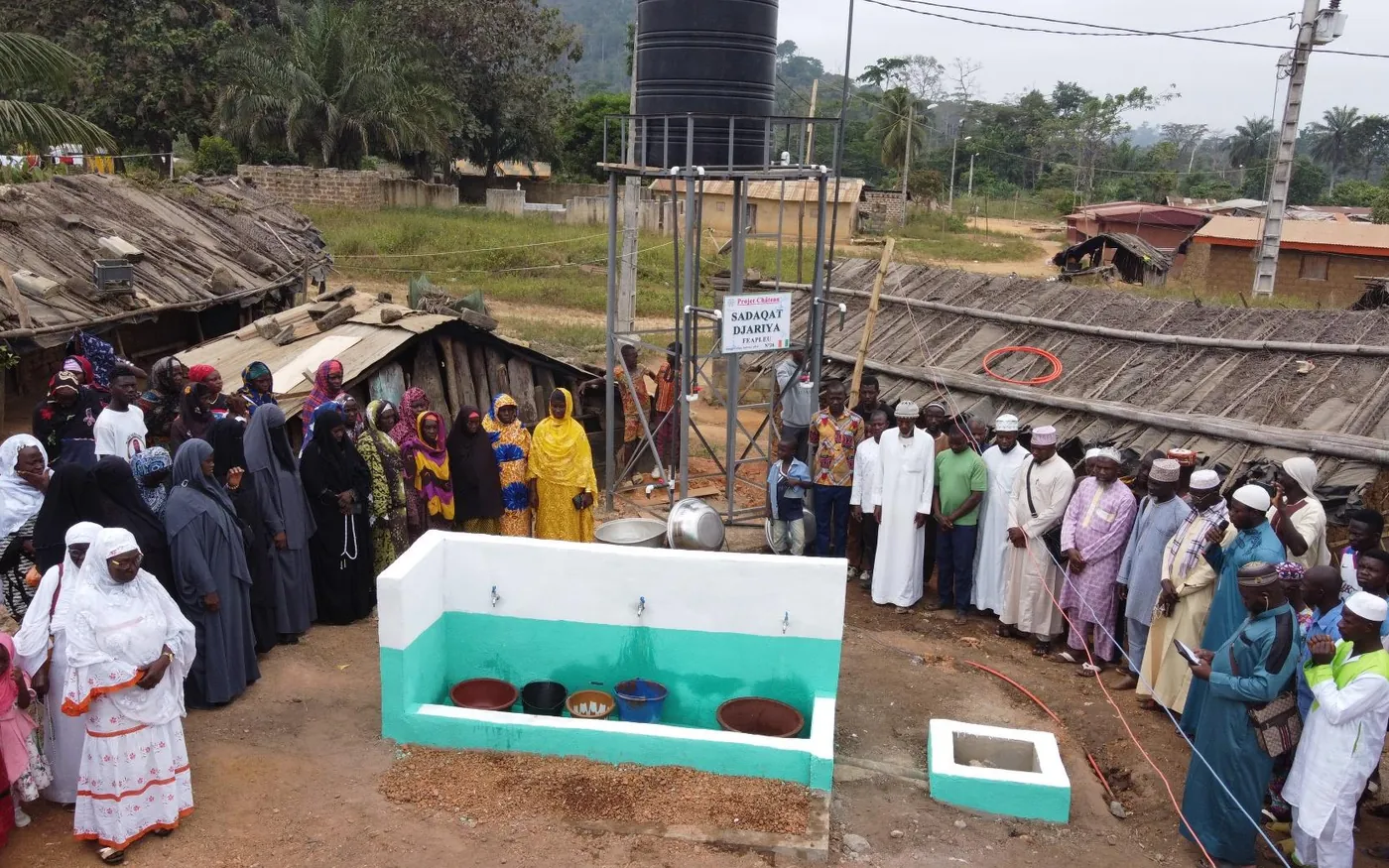 Villagers gathered around their new fountain