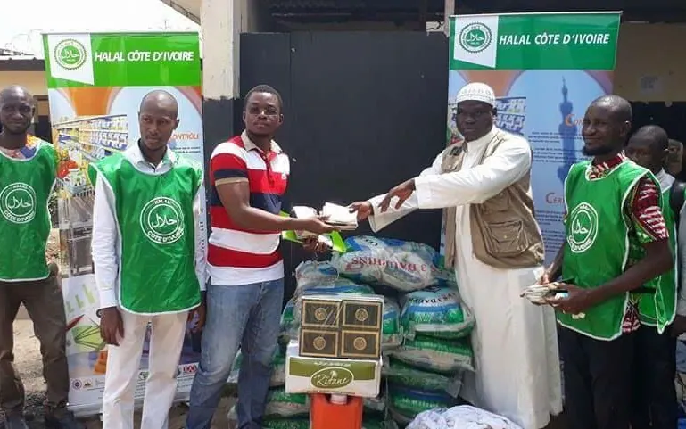 The AS-CI team hands kits to a community leader