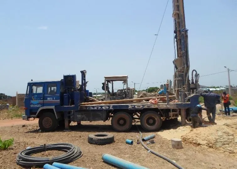 Drilling truck and blue pipes on the site
