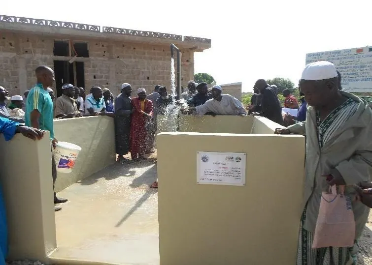 Villagers around the basin on inauguration day