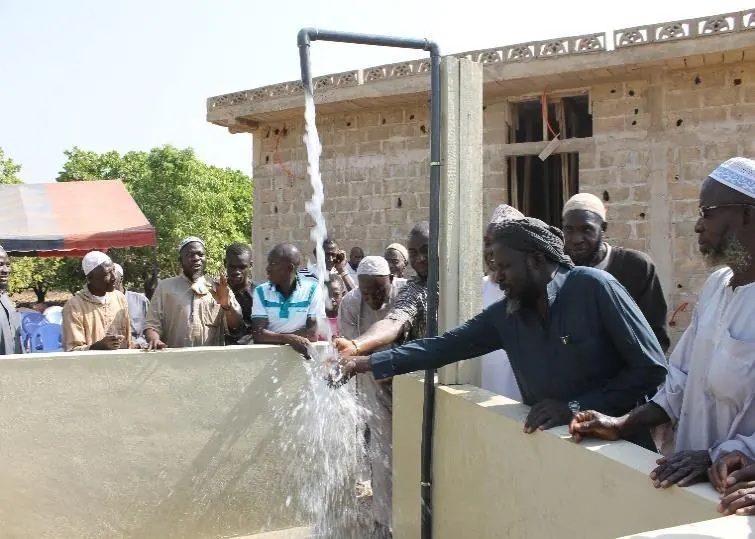Water gushes from the tap as villagers wash their hands