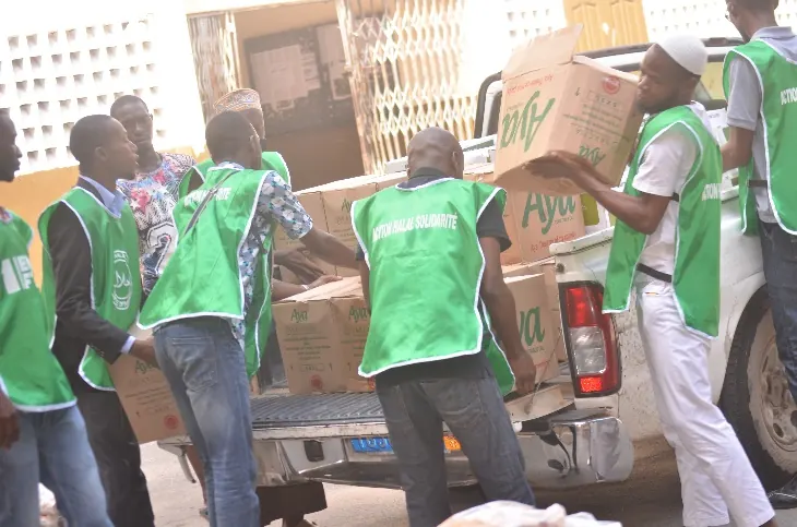 Volunteers unload a truck of kits
