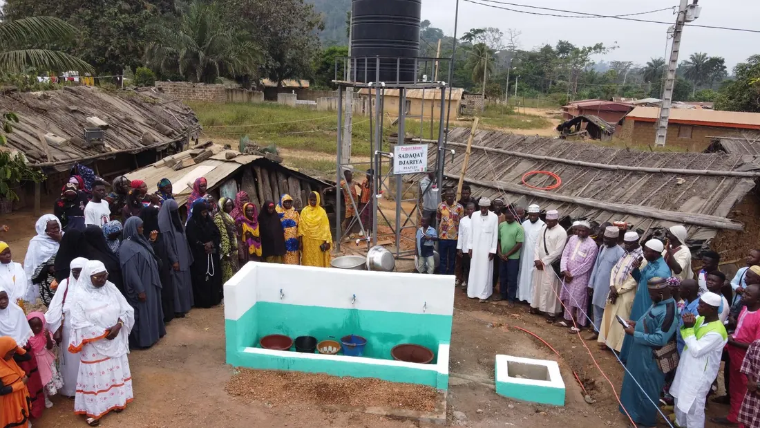 A whole village gathered around its new fountain
